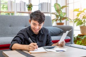 Man jotting down steps to follow before getting a loan