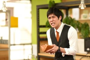 Distressed young man opening empty wallet, upset about money lender scams in Singapore