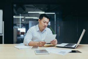 Man researching on ‘best licensed money lenders near me’ on computer