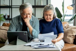 Old couple comparing private money lenders interest rates in Singapore