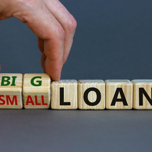 Wooden cubes with the letters ‘Big’ and ‘Small’ beside the word ‘Loan’