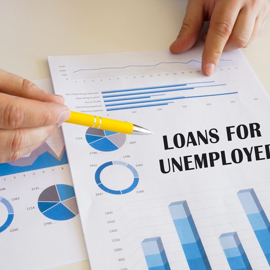 Loans for unemployed’ printed on a page with charts and graphs, emphasising need for credit loan Singapore