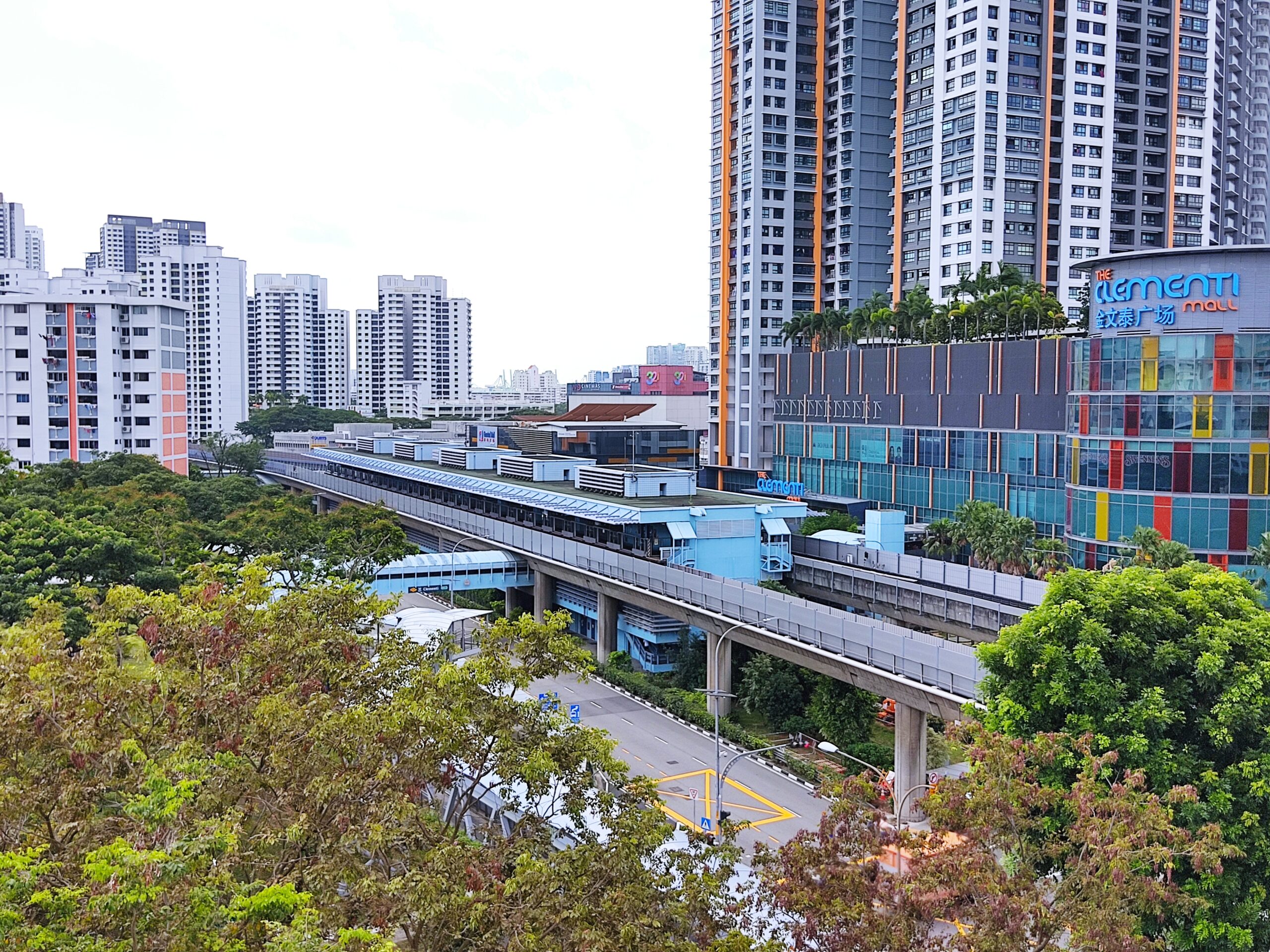 A long shot of the Clementi area, filled with greenery, apartments and Clementi Mall