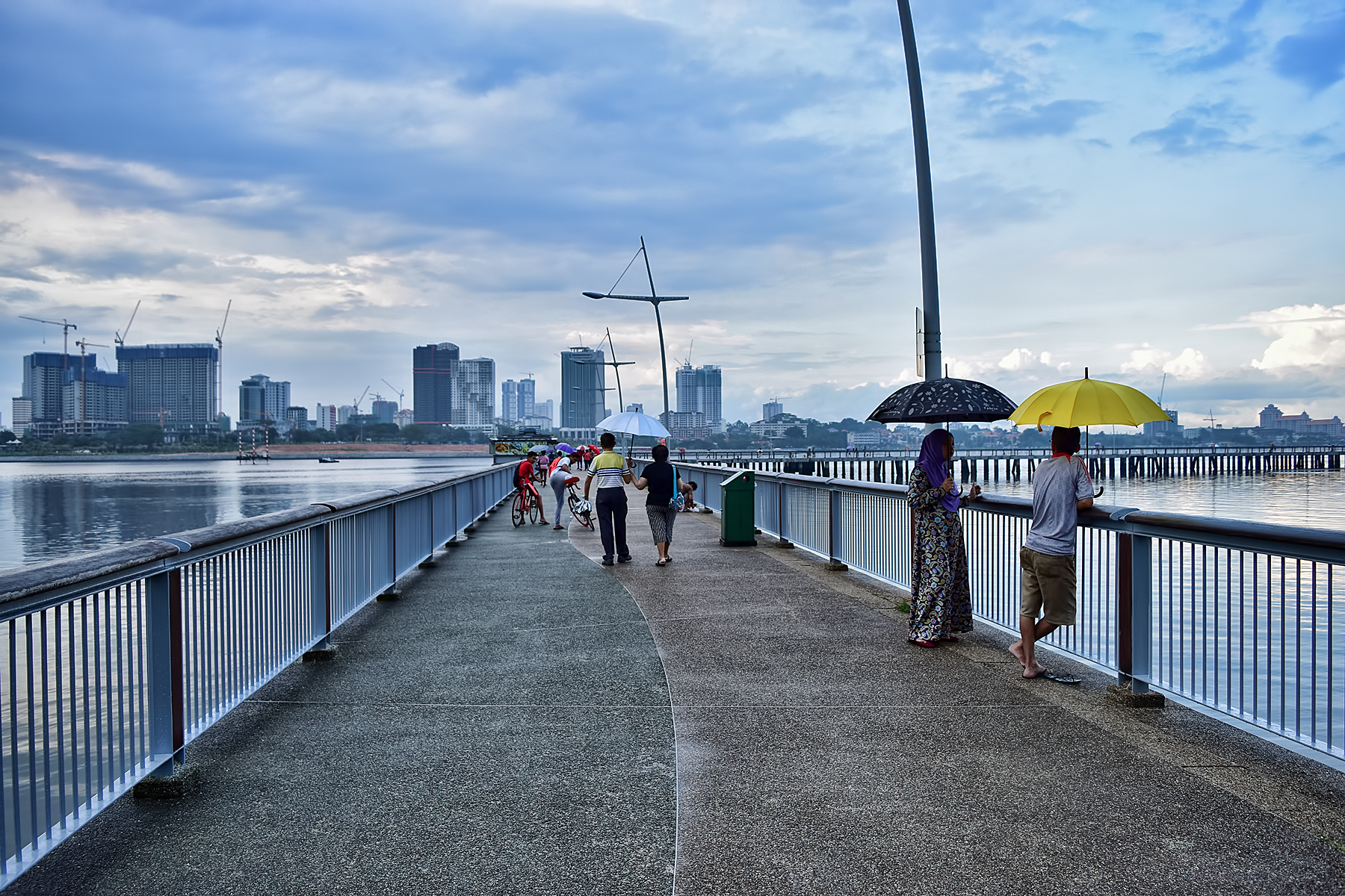 A shot of a pathway that leads to Woodlands Waterfront Park Jetty, overshadowed by cloudy skies