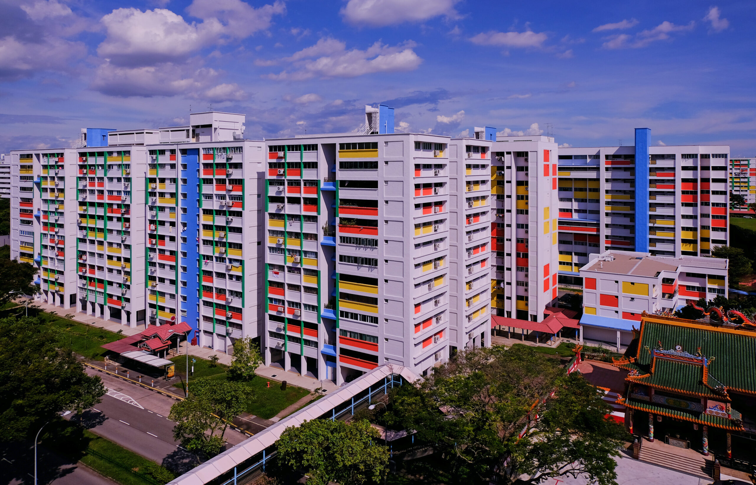 A wide angle, panoramic shot of bright-coloured HDB flats in Yishun